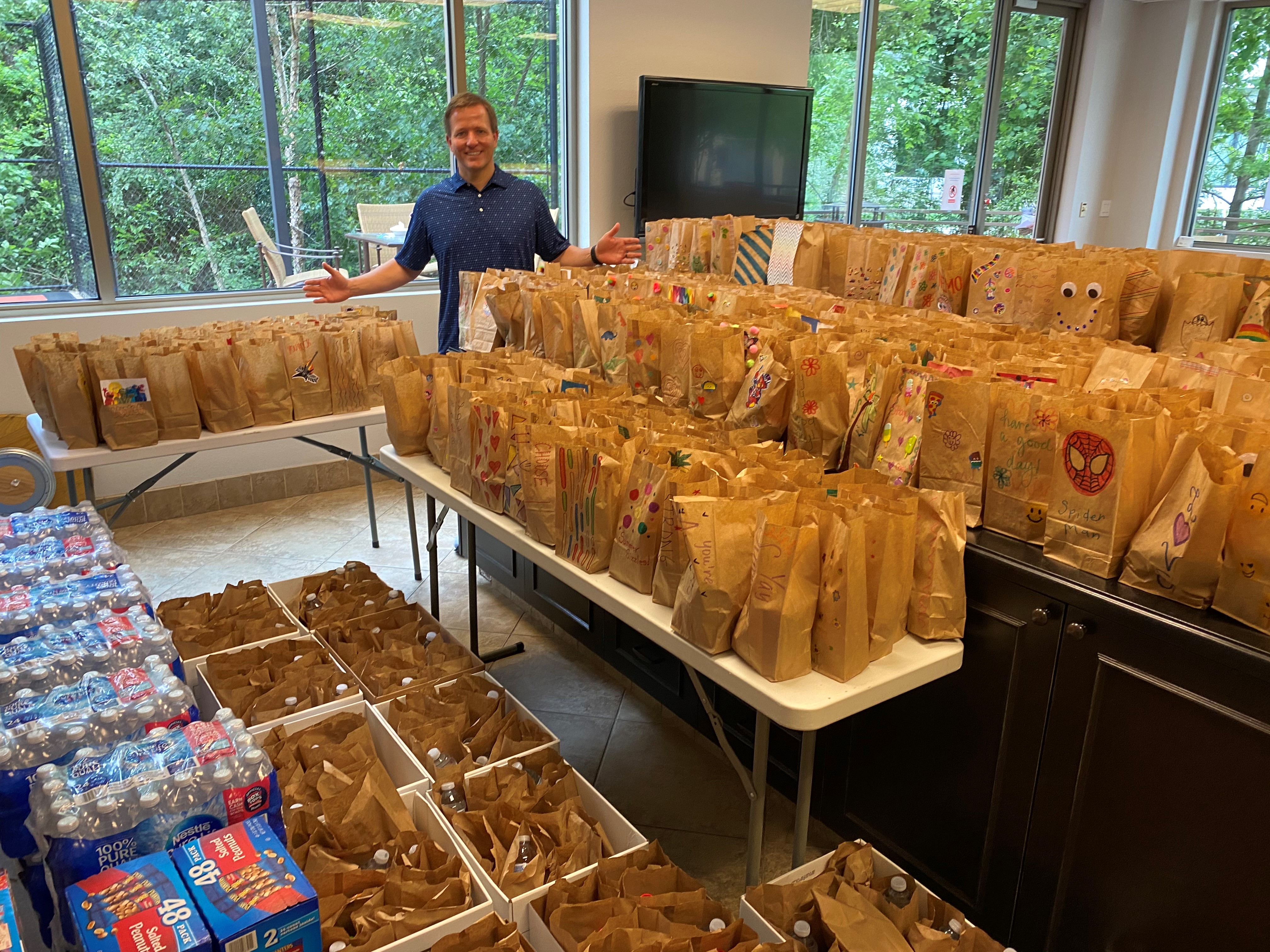 Kurt Arnold standing next to 600 lunches for Kids' Meals Inc. Kurt Arnold standing next to 600 lunches for Kids' Meals Inc.